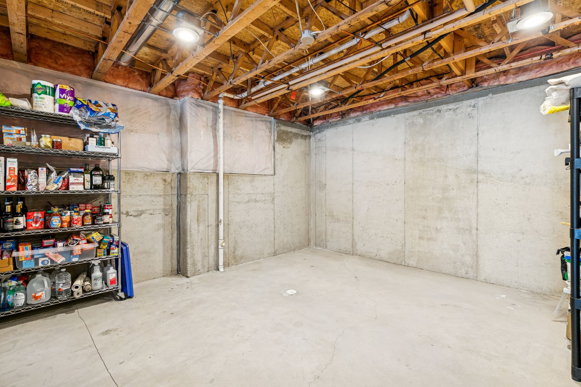 Unfinished lower level provides additional space ready for a second bedroom, and bathroom